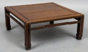 A late 19th/early 20th century Chinese low table Of panelled square form,