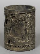 A Chinese patinated bronze brush pot Decorated in the round with figures and pagodas amongst