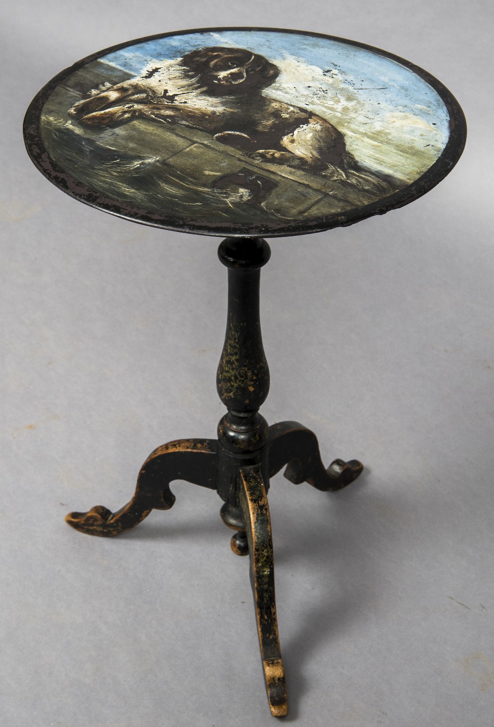 A 19th century painted slate topped tripod table The circular top decorated with a dog on a