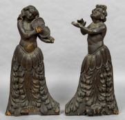 A pair of 18th century baroque carved pine figures, probably Venetian Each formed as a musician,