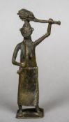 A Benin bronze figure of a woman Modelled wearing a skirt, holding a sword and a club. 22 cm high.