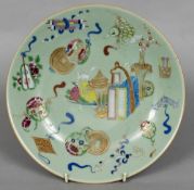 A 19th century Cantonese celadon plate Decorated with various objects and animals,