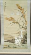 Two Chinese scroll paintings One depicting storks amongst a water filled landscape and with