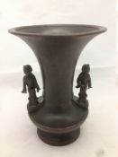 A Chinese bronze vase With flared rim, the shoulder mounted with two figures,