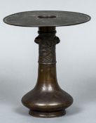 A Japanese bronze flower vase With flared rim and landscape cast band. 21 cm high.