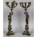 A pair of Empire patinated bronze candelabra Each with six branches above the figural stems,