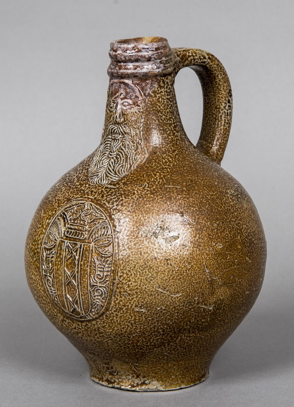 A small late 16th/early 17th century stoneware Bellarmine flagon Of typical form with moulded mask,