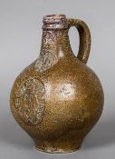 A small late 16th/early 17th century stoneware Bellarmine flagon Of typical form with moulded mask,