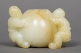 A Chinese carved pale and russet jade brush washer Worked as a gourd flanked by two children.