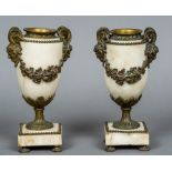 A pair of 19th century gilt metal mounted alabaster urns The handles worked as horned pan masks