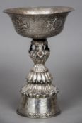 An antique Tibetan unmarked silver cup The flared bowl with engraved and repousse scrolling foliate