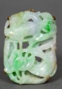 An unmarked gold framed pierced jade pendant Carved with a bird amongst foliage. 5 cm high.