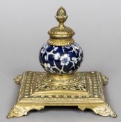 A Victorian brass mounted pottery inkwell The spherical body worked with prunus blossom. 13.