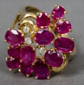 A 14 K gold diamond and ruby ring Of cluster form. 2.5 cm high.