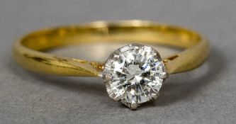 An 18 ct gold diamond solitaire ring The claw set stone spreading to between 0.25 and 0.