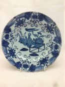 An antique blue and white Delft plate Decorated with vases issuing flowers in the Chinese style. 22.