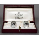 A pair of enamel decorated unmarked silver cufflinks Each decorated with a dog's head,