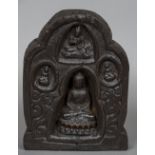 An antique Tibetan carved wooden shrine Of standing lappet form carved with four views of Buddha.