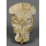 A Chinese Han dynasty gold inlaid and carved jade pendant Worked as a stylised dragon mask.