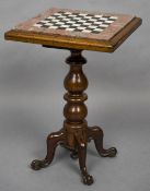 A Victorian marble topped mahogany games table The inset marble top centred with a chessboard,