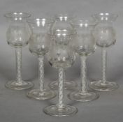 A set of six air twist wine glasses The engraved ogee bowls with triple helix stems and folded