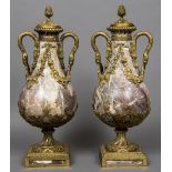 A pair of 19th century Continental ormolu mounted variegated marble twin handled urns and