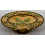 A Victorian gilt metal malachite set tazza With engraved strapwork. 33 cm diameter.