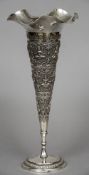 An Eastern white metal trumpet vase With wavy rim and embossed figural decoration,