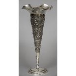 An Eastern white metal trumpet vase With wavy rim and embossed figural decoration,