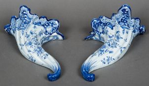 A pair of faience blue and white wall pockets Each of folded cornucopia form decorated with floral