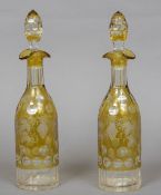 A pair of amber flashed cut glass decanters and stoppers Each decorated with fruiting vine. 35.