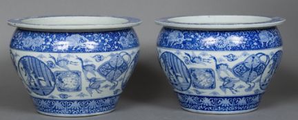 A pair of Chinese blue and white jardinieres Each decorated in the round with floral scrollwork,