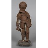 A small articulated model of a suit of armour,