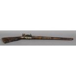 An antique North African mother-of-pearl and metal inlaid flintlock rifle 95 cm long.