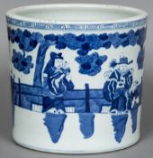 A large 19th century Chinese blue and white brush pot Decorated with courtly figures in a fenced