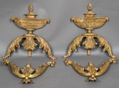 A pair of 18th/19th century carved giltwood crestings Each formed as a flaming antiquity urn above