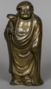 A 19th century Chinese patinated bronze figure Formed wearing flowing robes holding a ruyi sceptre.