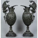 A pair of 19th century bronze ewers Each extensively cast with scrolling acanthus and mythical