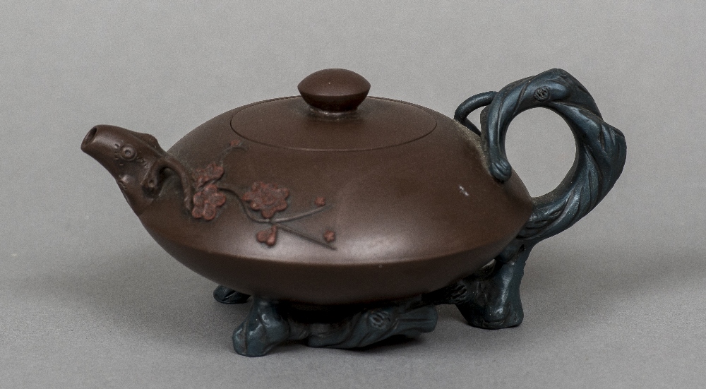 A Chinese Yixing pottery teapot and cover The handle, spout and feet naturalistically modelled,