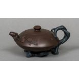 A Chinese Yixing pottery teapot and cover The handle, spout and feet naturalistically modelled,