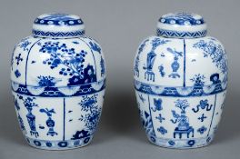 A pair of Chinese blue and white porcelain ginger jars and covers Each worked with precious objects