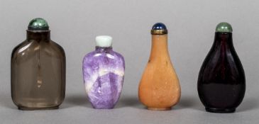 Four various Chinese glass and hardstone snuff bottles Each with cabochon stoppers. The largest 7.