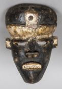 A 19th century African carved wood mask With traces of white pigment. 28 cm high.