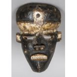 A 19th century African carved wood mask With traces of white pigment. 28 cm high.