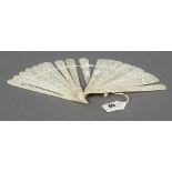 A 19th century Chinese carved ivory fan The end guards and blades worked with figures in a