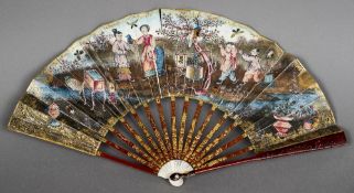 A late 18th century gilt on red lacquered tortoiseshell and ivory mounted decorated fan Worked with