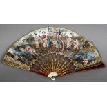 A late 18th century gilt on red lacquered tortoiseshell and ivory mounted decorated fan Worked with