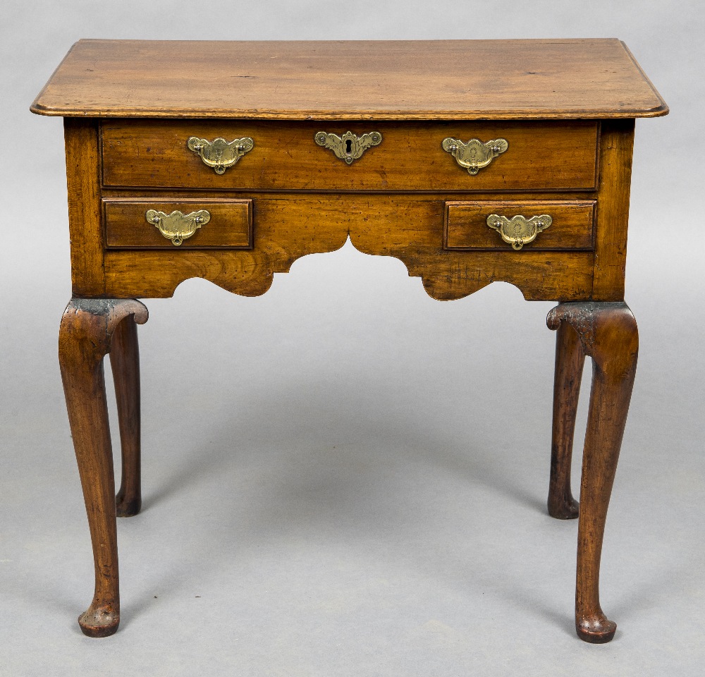 An 18th century walnut and fruitwood lowboy The moulded rounded rectangular top above one long and