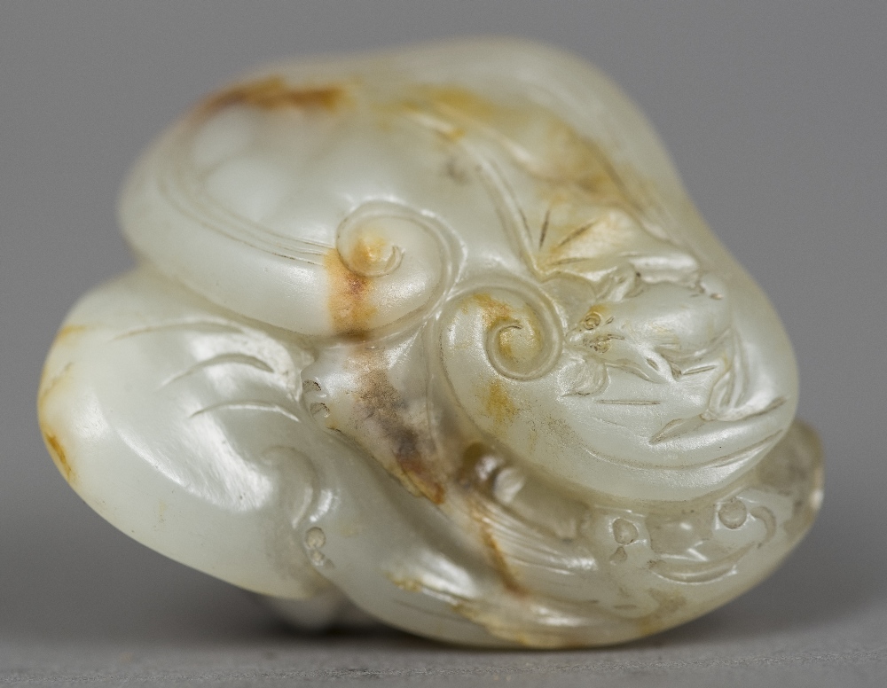 A Chinese carved russet jade group Worked with Lingzhi. 4 cm wide.