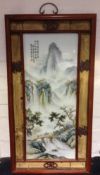 A Chinese porcelain panel Decorated with figures in a mountainous river landscape,